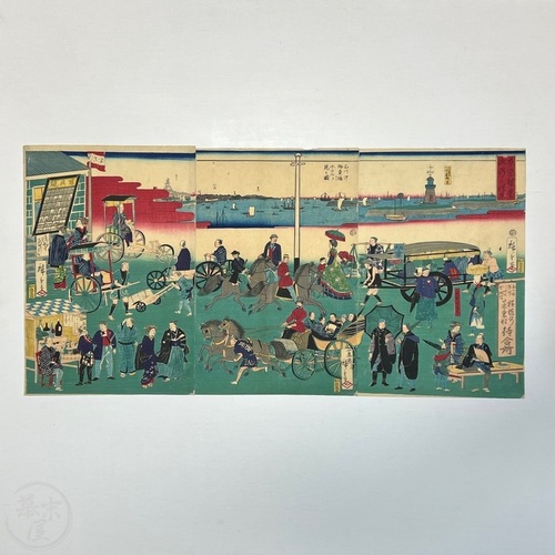 Woodblock printed triptych of Tokyo's Prosperity and Bustling Streets with photo studio display board visible